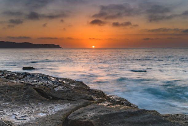 capturing the sunrise from pearl beach on the central coast, nsw, australia.